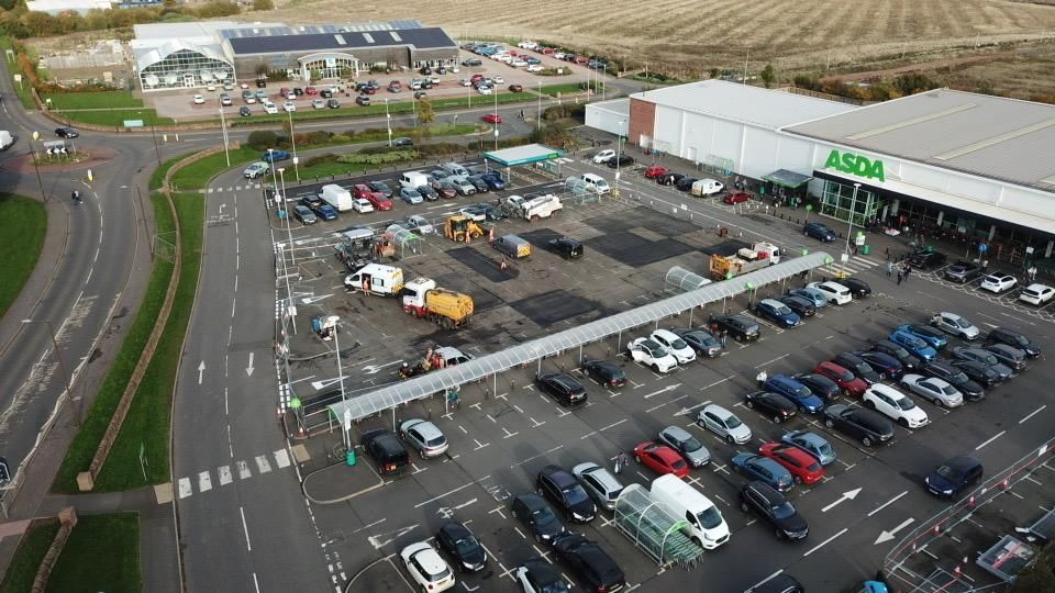 Aerial view of the whole car park with the resurfaced strip and plant on site.