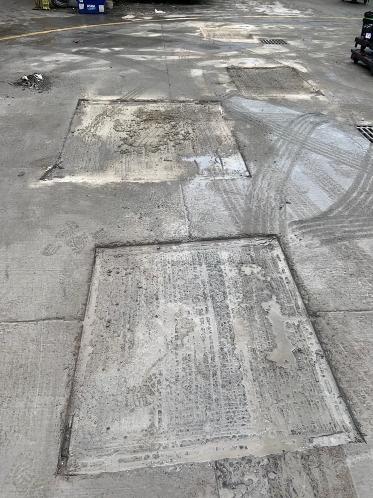 Two concrete reinstatement bays set into the yard surface after repair.