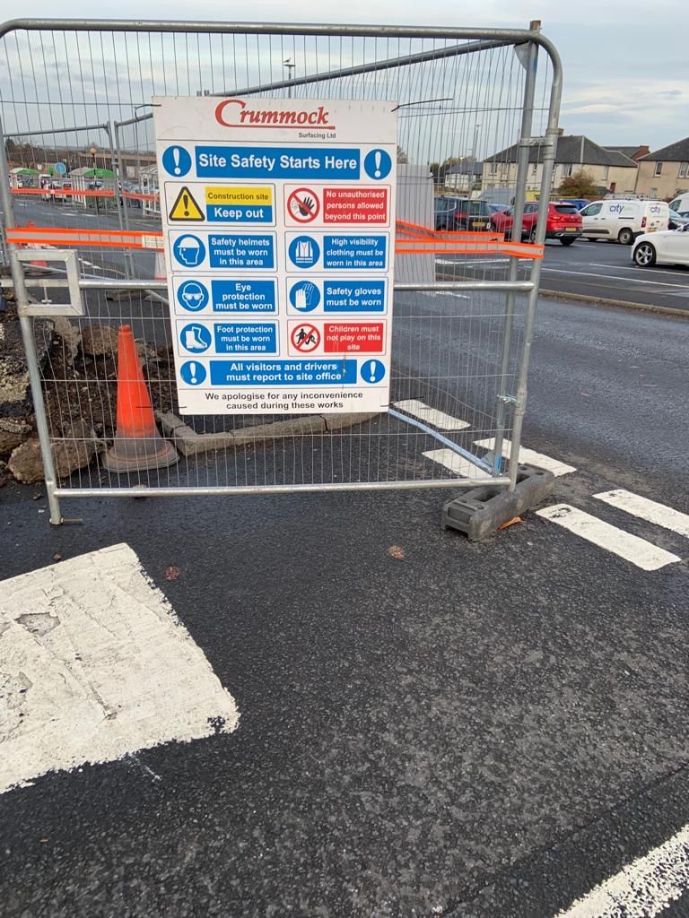 Crummock site safety board fixed to Heras fencing at the entrance to the works.