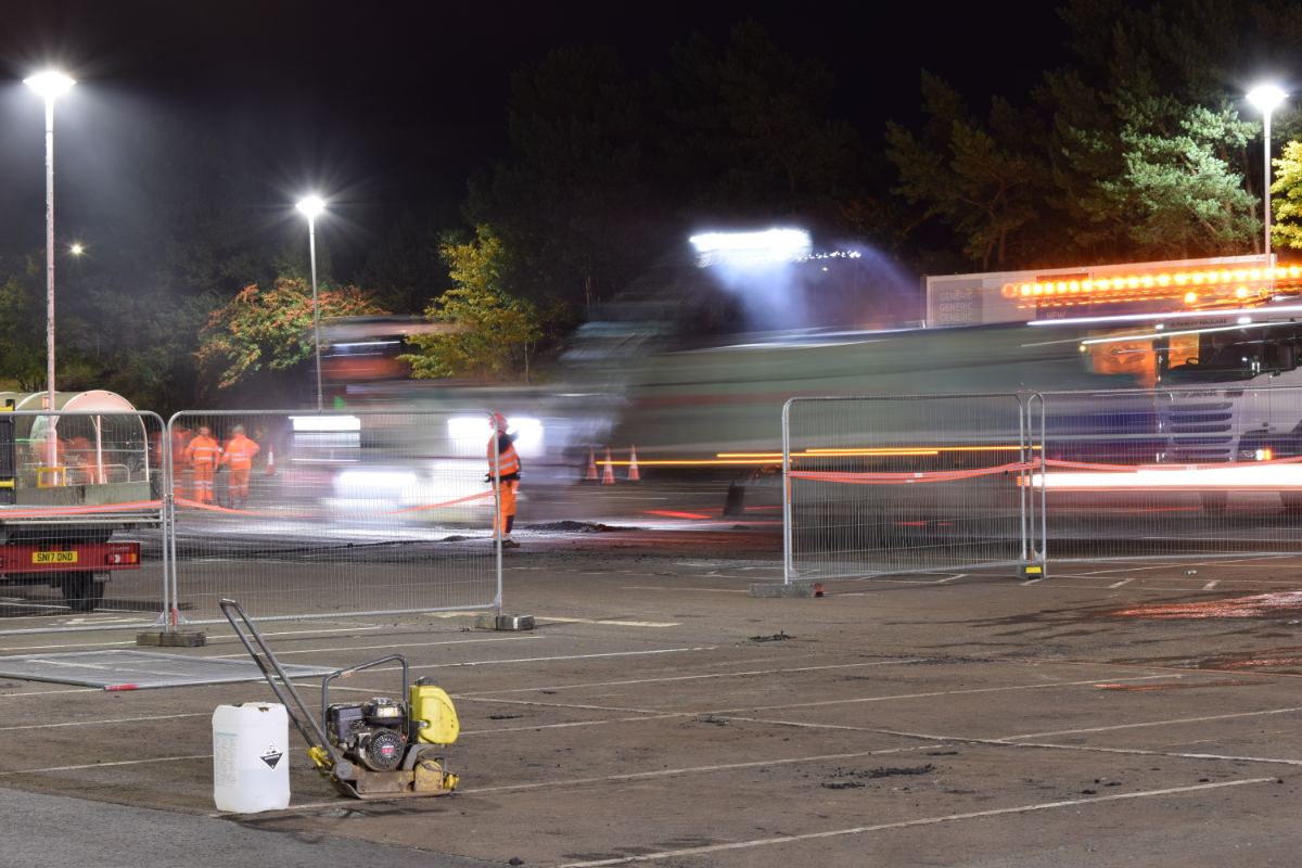 Heras fencing enclosing a resurfacing section while the retail site stays open